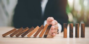 Human hands blocking wooden sticks